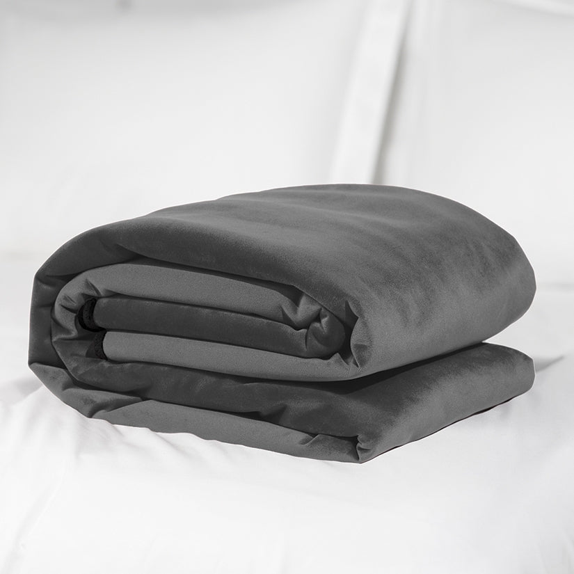 Folded gray comforter on a white background