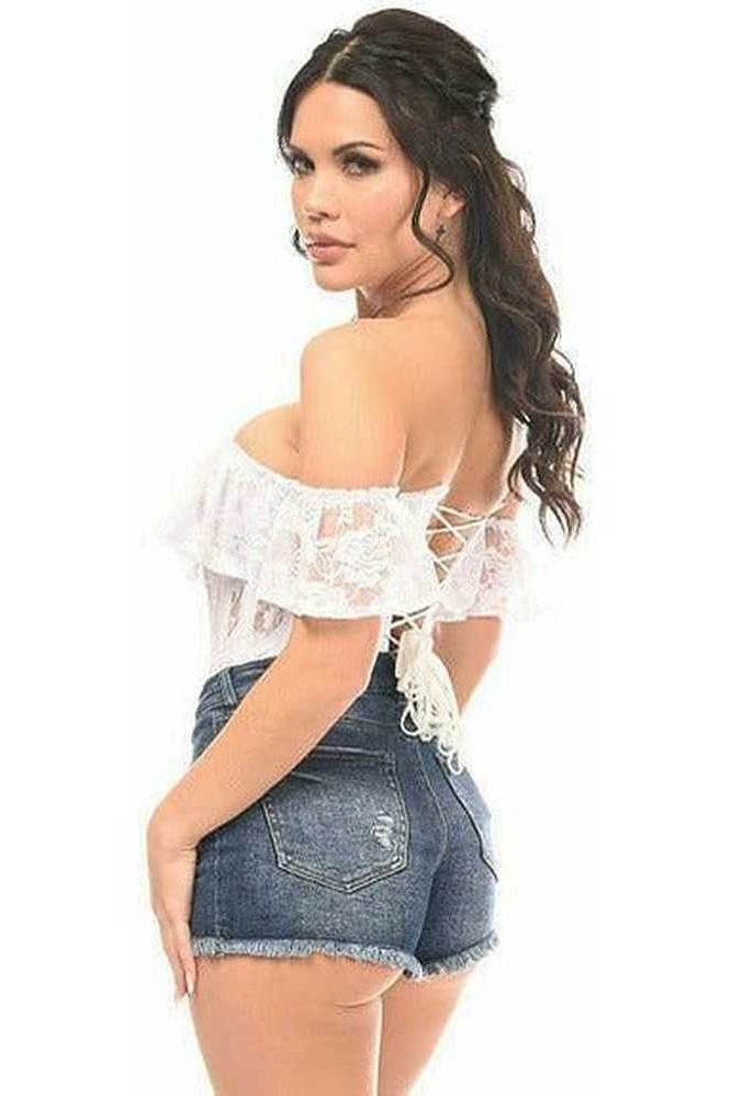 Woman wearing a white lace top and denim shorts on a white background