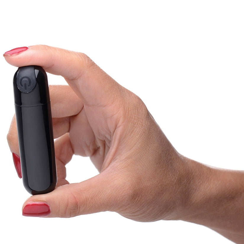 Hand holding a black electronic device on a white background