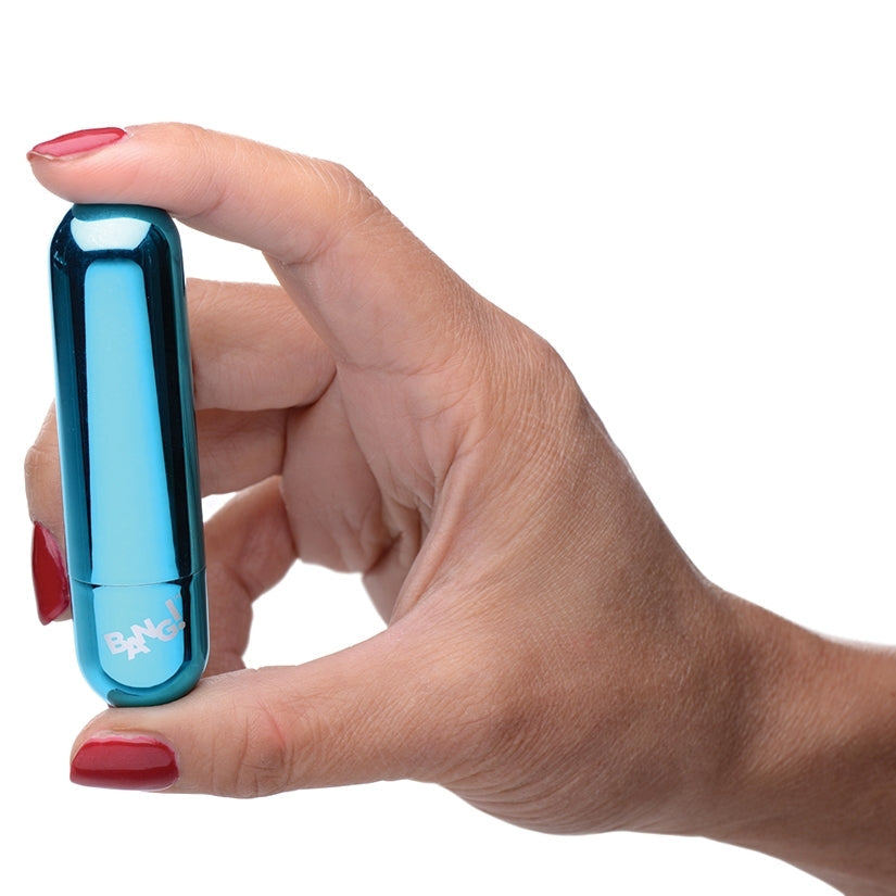 Hand holding a blue cylindrical object with 'BANG' branding on a white background