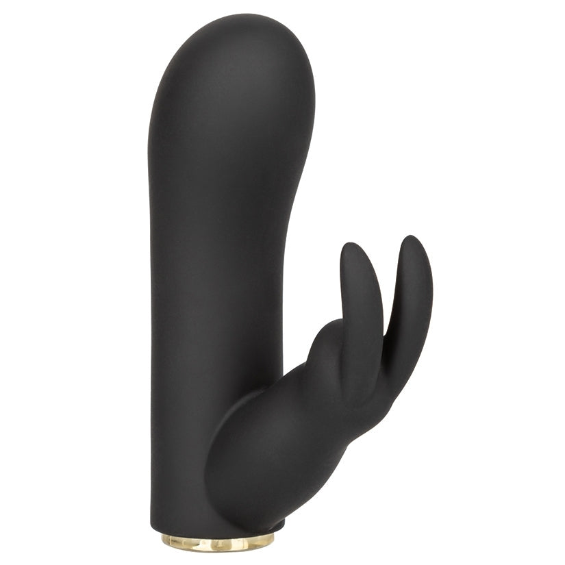 Black hand-shaped object with a gold base on a white background