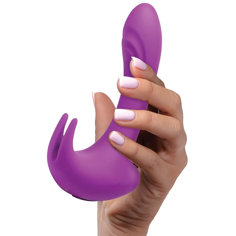 Purple silicone tool held by a hand with light pink nail polish on a white background